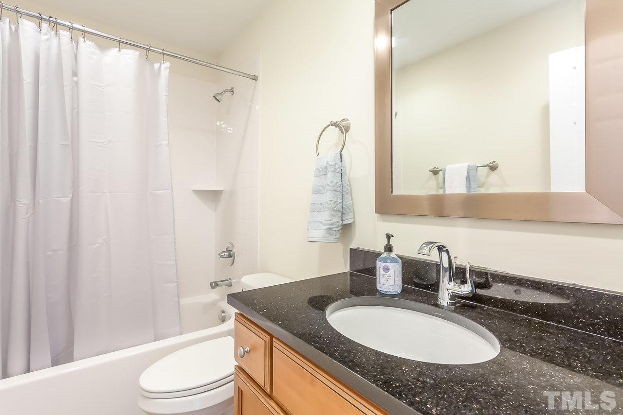 620 Brighton Road Raleigh, NC 27610 - Photo 20 of 25 a bathroom with a granite countertop sink and a mirror with toilet