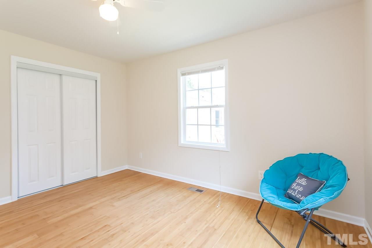 620 Brighton Road Raleigh, NC 27610 - Photo 22 of 25 an empty room with wooden floor and windows