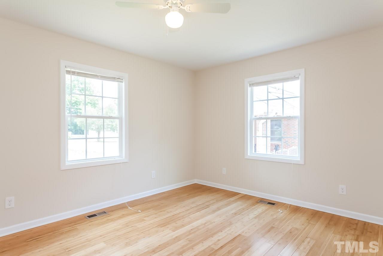 620 Brighton Road Raleigh, NC 27610 - Photo 23 of 25 an empty room with wooden floor and windows