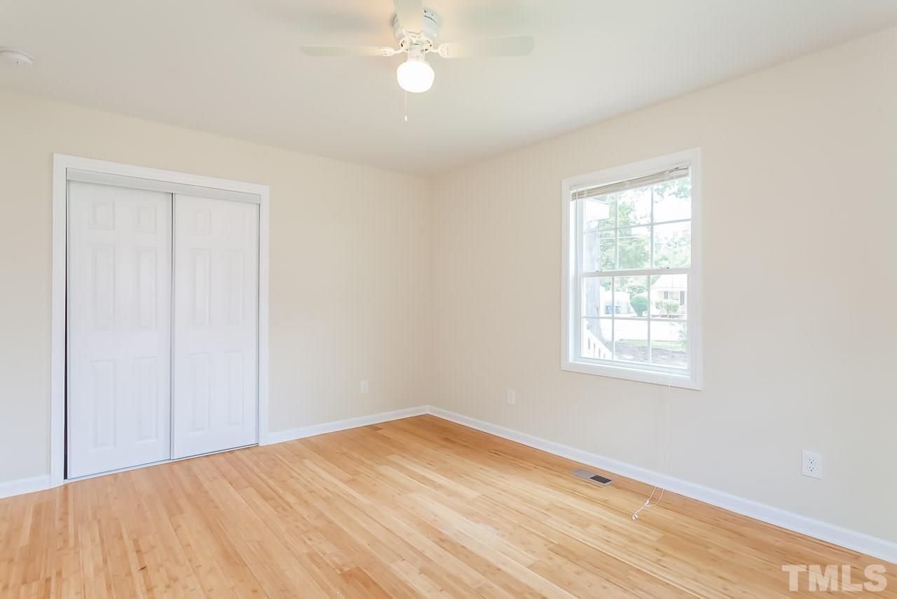 620 Brighton Road Raleigh, NC 27610 - Photo 24 of 25 an empty room with wooden floor and windows