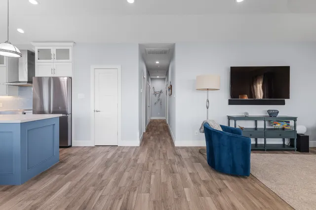a bedroom with bed and a flat tv screen on dresser