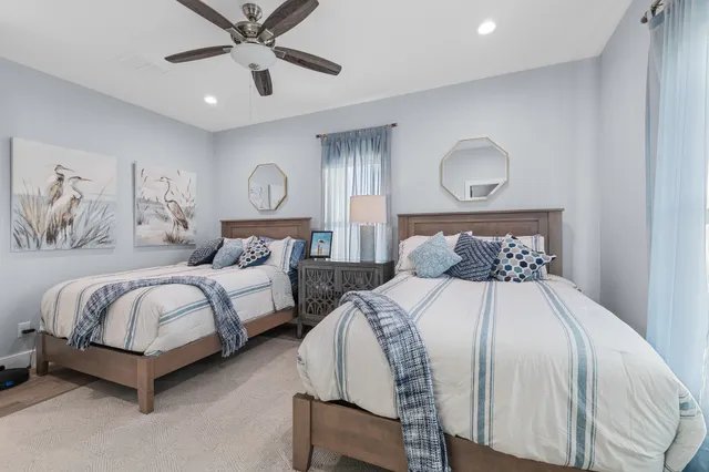 a bedroom with two beds and a chandelier