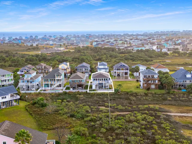 an aerial view of residential houses with outdoor space