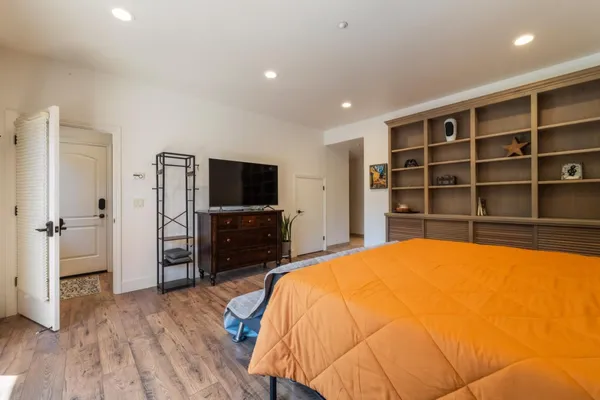 a bedroom with a bed and a flat screen tv
