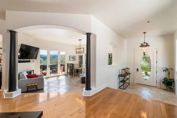 a living room with furniture a flat screen tv and a dining table with garden view