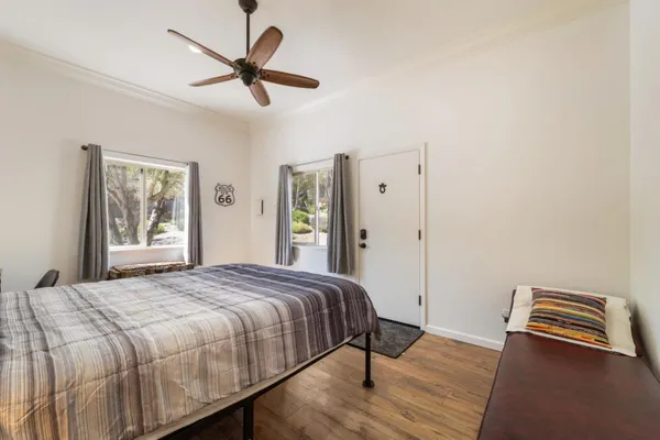 a bedroom with a bed and wooden floor