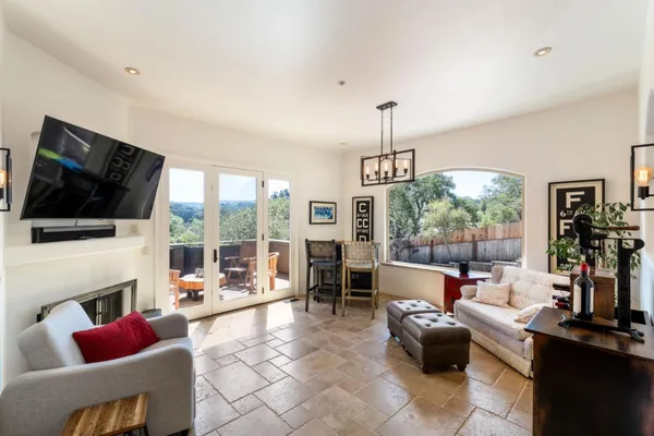 a living room with fireplace furniture and a flat screen tv