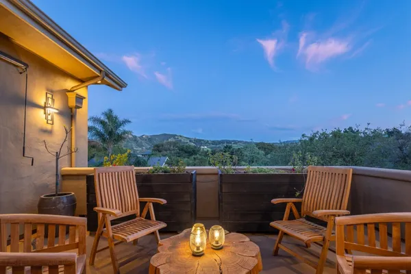 a view of a chair and tables the patio