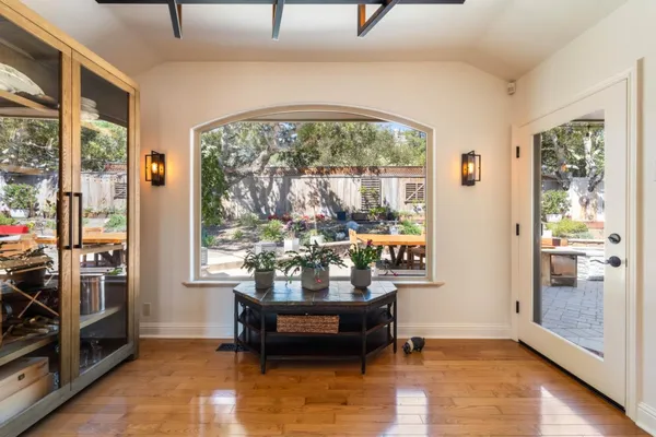 a living room with furniture and a floor to ceiling window