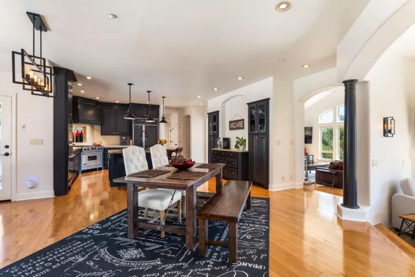 a dining room with furniture and wooden floor
