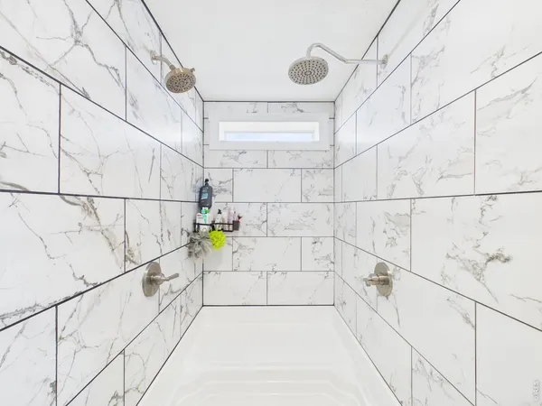 a bathroom with a bathtub and shower