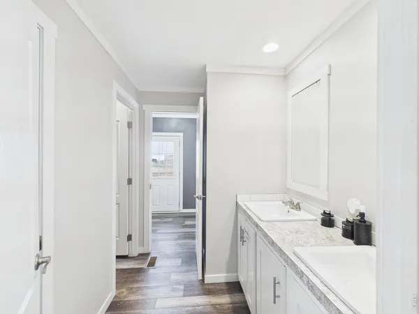 a bathroom with a double vanity sink a mirror and a shower