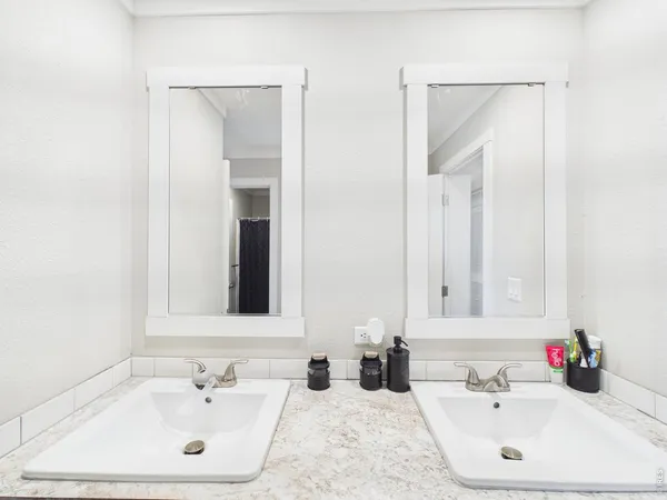 a bathroom with a sink vanity and mirror