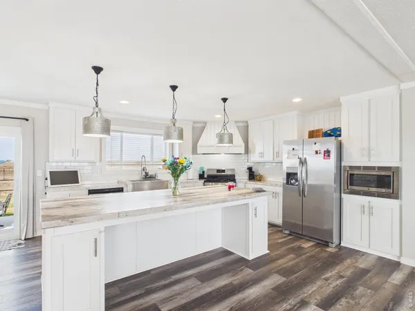a kitchen with stainless steel appliances a refrigerator sink and cabinets