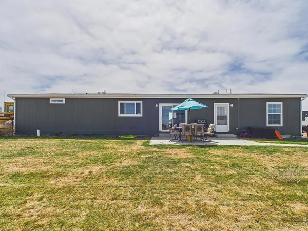 a view of a house with swimming pool and a yard
