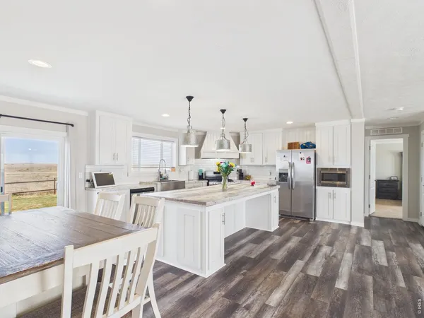 a kitchen that has a lot of cabinets in it and appliances