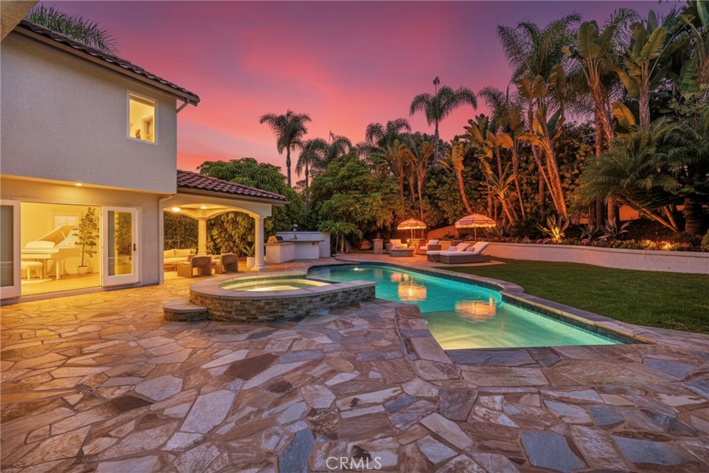 20 Regina Dana Point, CA 92629 - Photo 10 of 60 Stunning twilight view of the property’s backyard with a beautifully lit pool area.