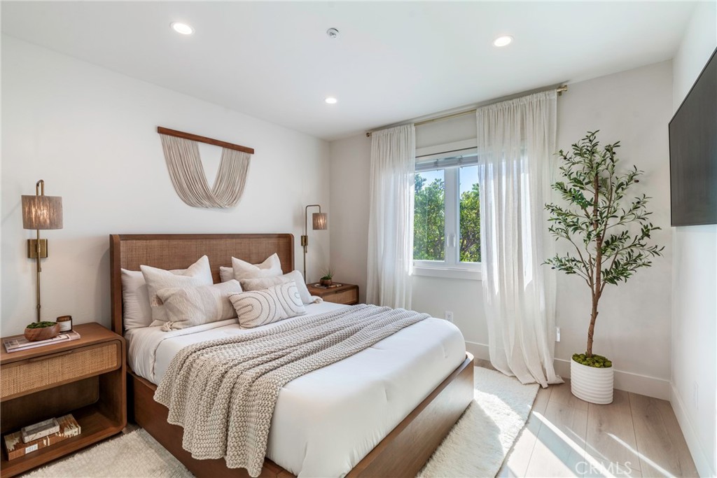 20 Regina Dana Point, CA 92629 - Photo 34 of 60 a bedroom with bed and a potted plant