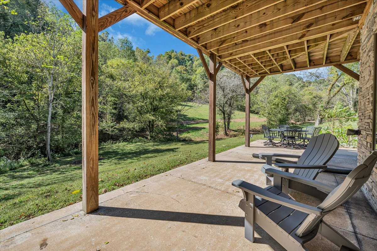 317 Little Creek Road Pleasant Shade, TN 37145 - Photo 60 of 64 a view of a patio with a table chairs and a backyard