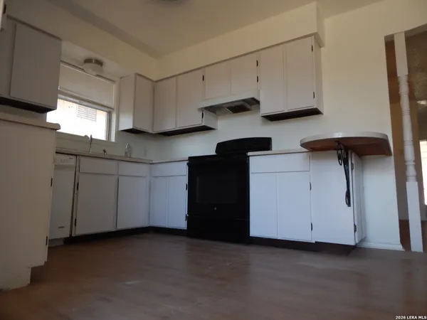 a kitchen with cabinets and white appliances