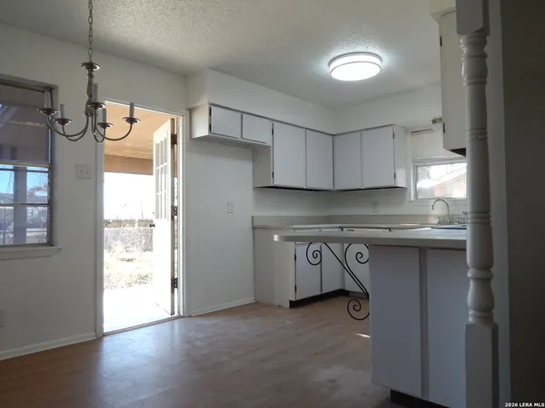 a kitchen with granite countertop a sink and a refrigerator