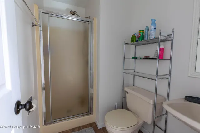 a bathroom with a toilet and a shower