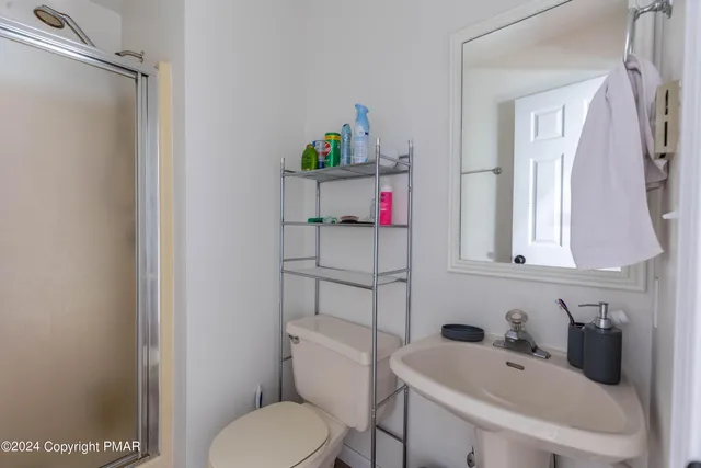 a bathroom with a sink mirror vanity and toilet