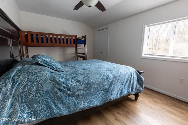 a bed sitting in a bedroom next to a window