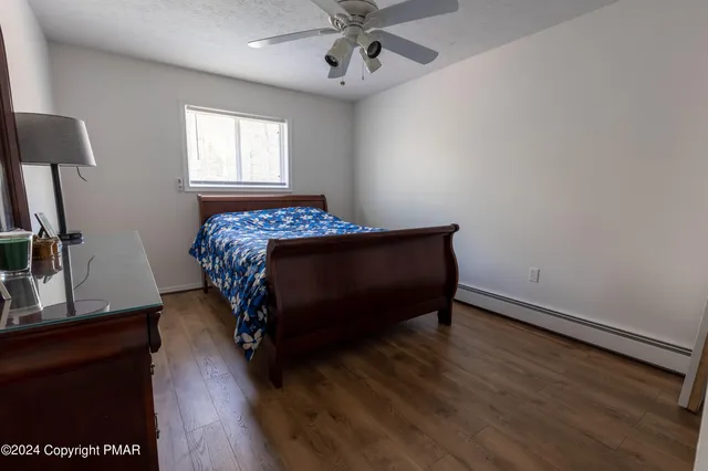 a bed sitting in a bedroom next to a window