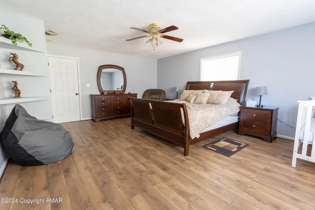 a spacious bedroom with a bed and a couch