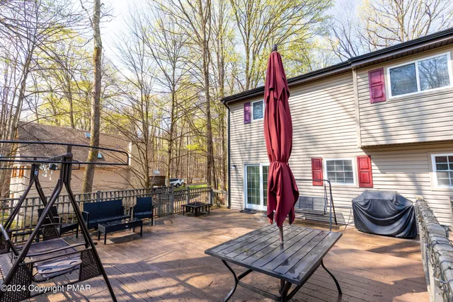a view of a chairs and table in the back yard of the house