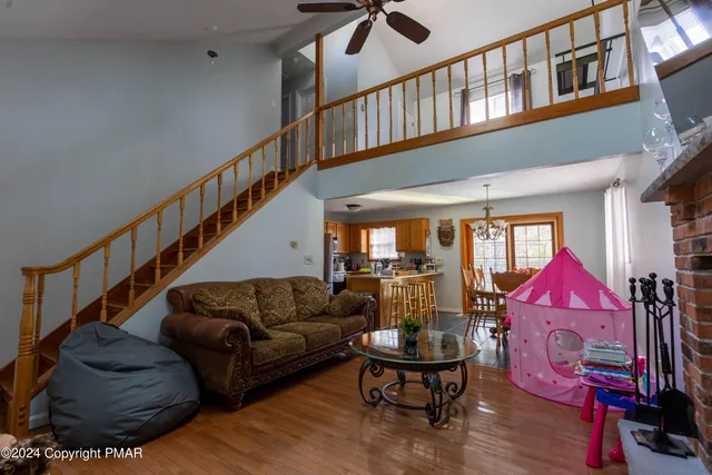 a living room with furniture or couch and a ceiling fan