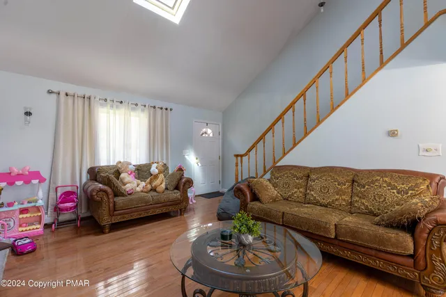 a living room with furniture and a couches