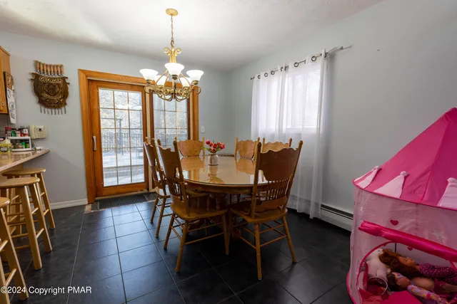 a view of a dining room with furniture and window