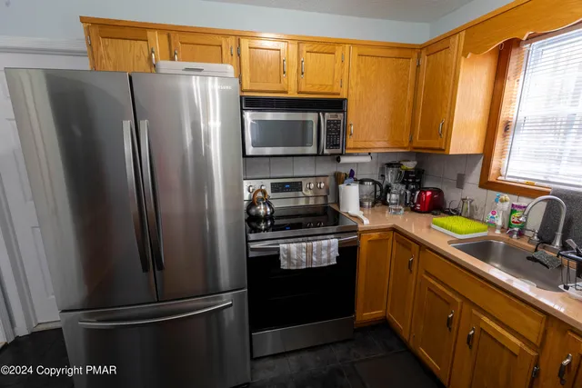 a kitchen with a refrigerator sink and microwave