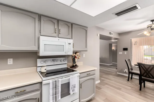 a kitchen with a stove and white cabinets
