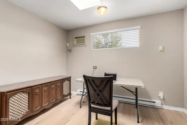 a view of a dining room with furniture and a window