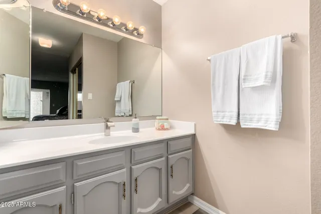 a bathroom with a double vanity sink and mirror