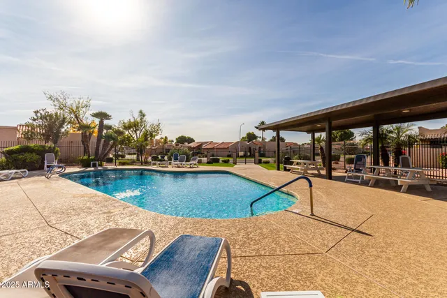 a swimming pool with chairs
