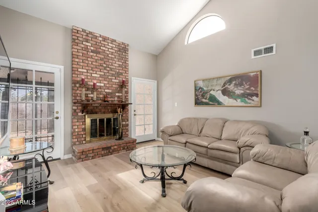 a living room with furniture a dining table and a fireplace