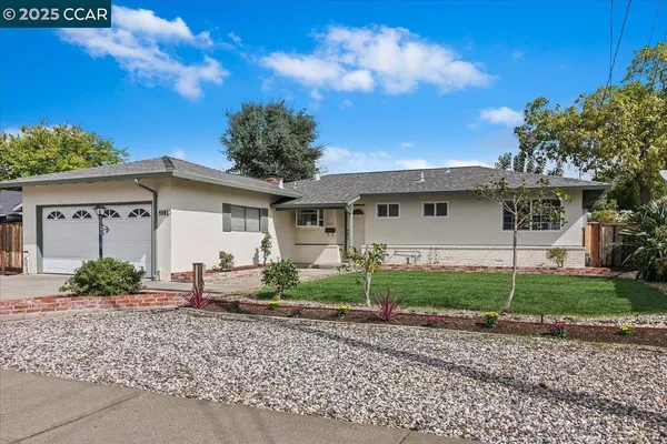 a view of a house with a backyard and a garden