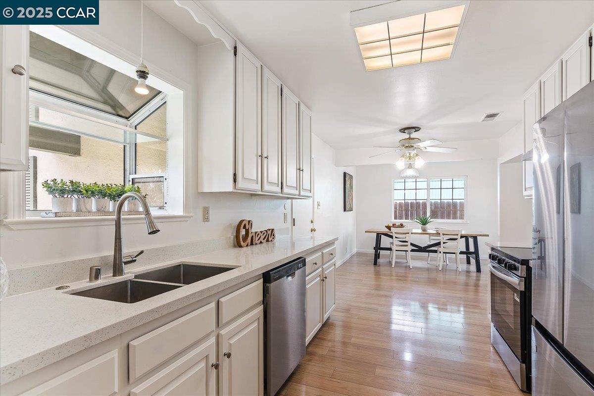 4081 Salem Street Concord, CA 94521 - Photo 6 of 27 a kitchen with stainless steel appliances a sink a stove a refrigerator and cabinets