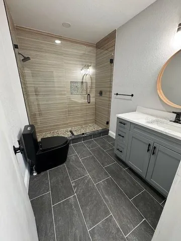 a bathroom with a sink a toilet and a mirror