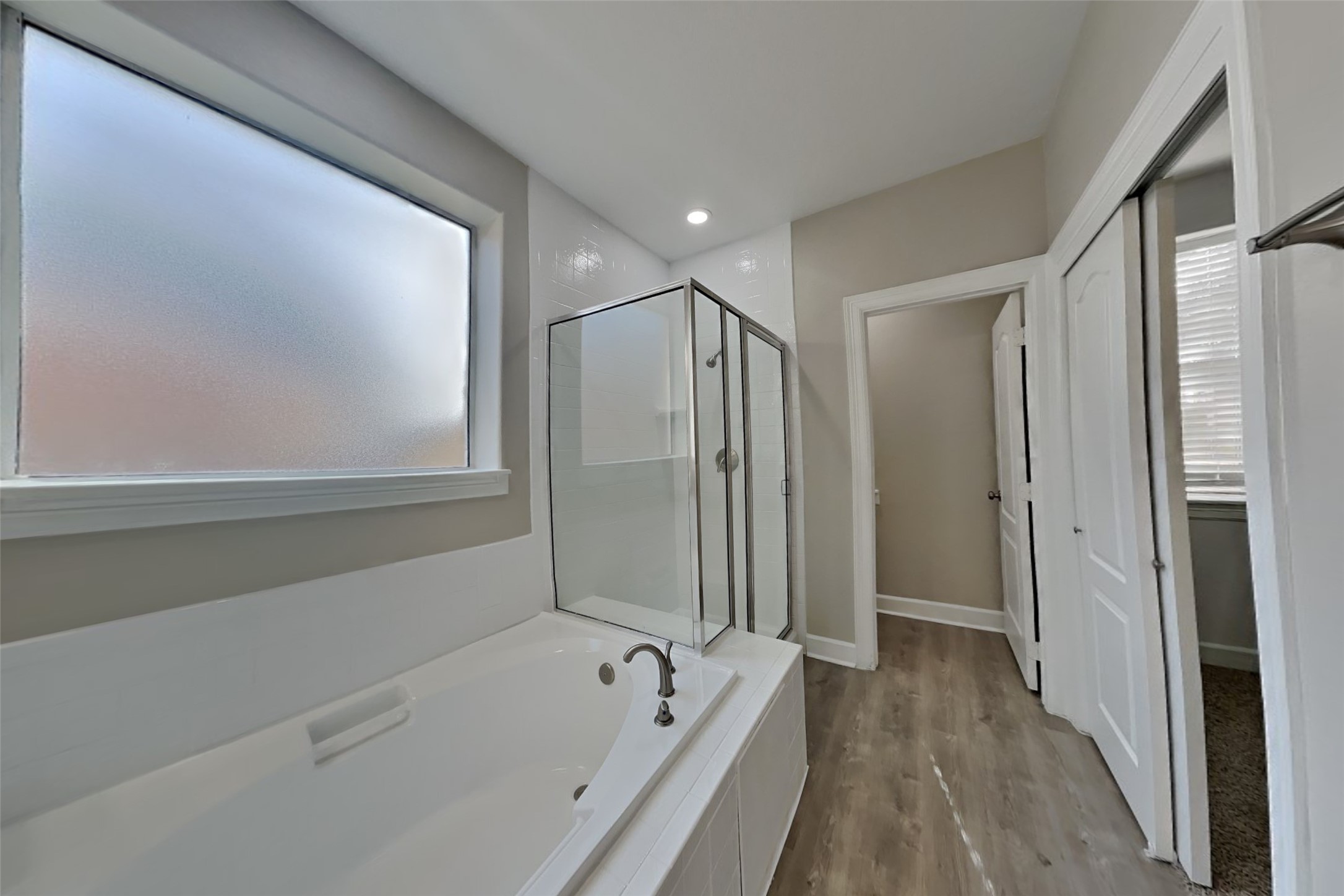 4718 Wild Bluebonnet Way Houston, TX 77084 - Photo 9 of 20 a bathroom with a bathtub and a shower