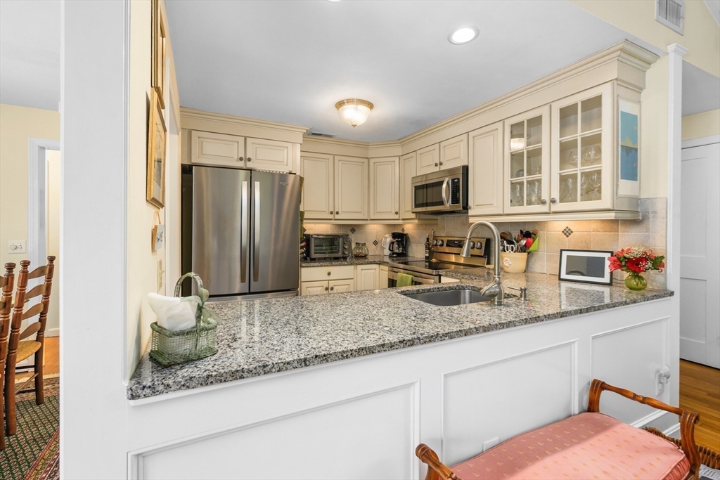 1 Seastrand Way, Unit 1 Chatham, MA 02633 - Photo 12 of 35 a kitchen with stainless steel appliances granite countertop a refrigerator and a sink