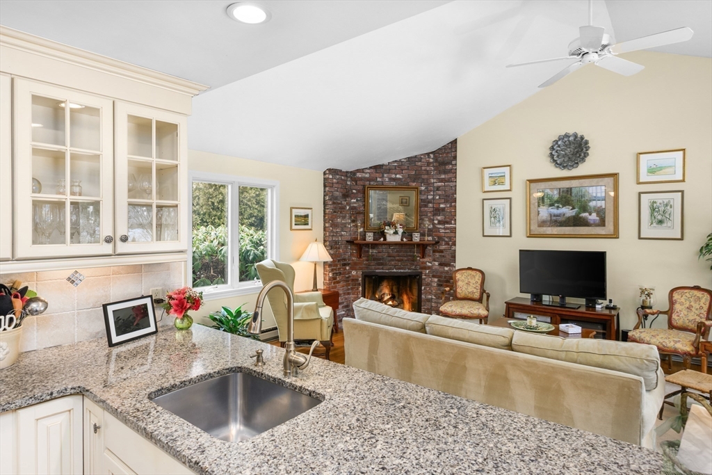 1 Seastrand Way, Unit 1 Chatham, MA 02633 - Photo 13 of 35 a kitchen with kitchen island granite countertop a sink a counter top space and living room view