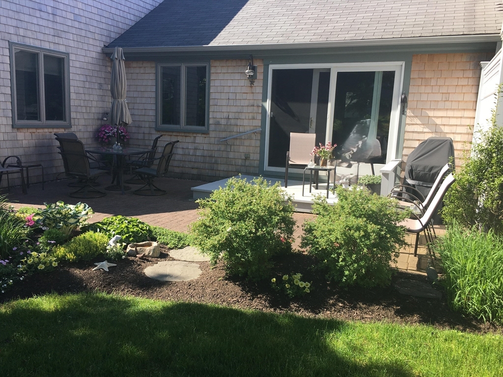 1 Seastrand Way, Unit 1 Chatham, MA 02633 - Photo 2 of 35 a front view of a house with a yard