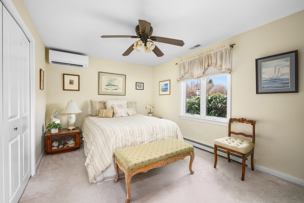1 Seastrand Way, Unit 1 Chatham, MA 02633 - Photo 23 of 35 a bedroom with a bed and a chandelier
