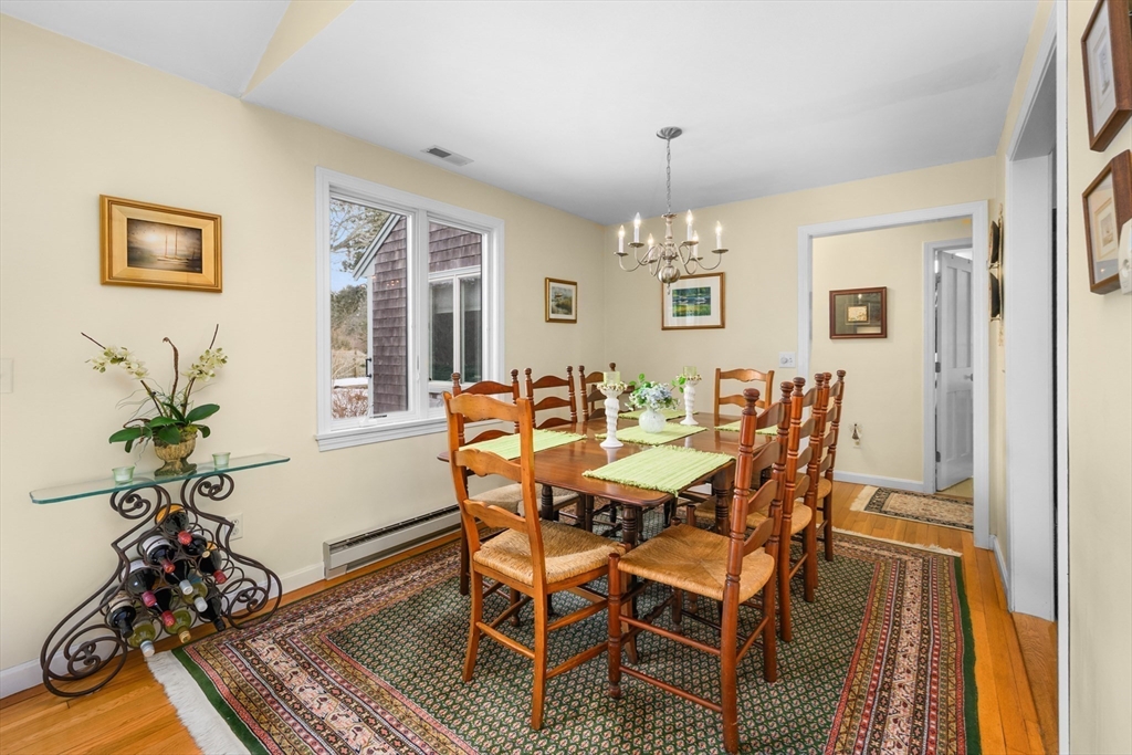 1 Seastrand Way, Unit 1 Chatham, MA 02633 - Photo 8 of 35 a view of a dining room with furniture window and wooden floor