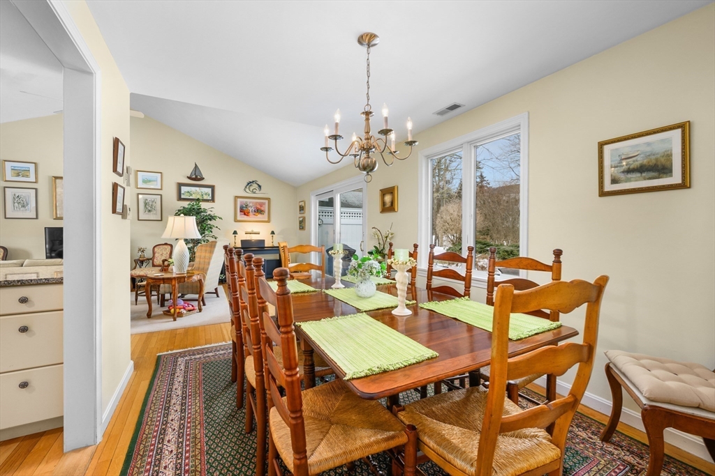 1 Seastrand Way, Unit 1 Chatham, MA 02633 - Photo 9 of 35 a view of a dining room with furniture and a chandelier